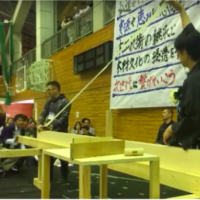 Contestant pulling a shaving during a planing competition