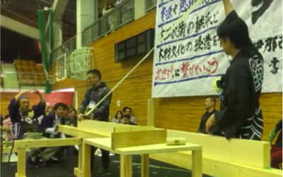 Contestant pulling a shaving during a planing competition