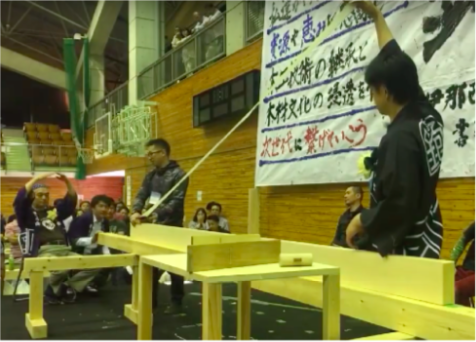 Contestant pulling a shaving during a planing competition